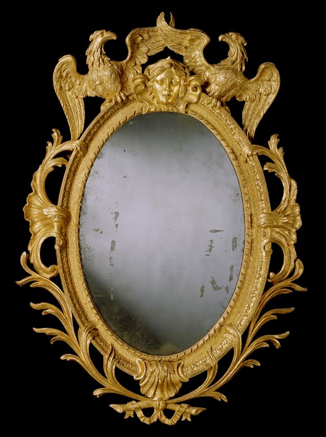 A GEORGE II CARVED GILTWOOD OVAL MIRROR | MasterArt